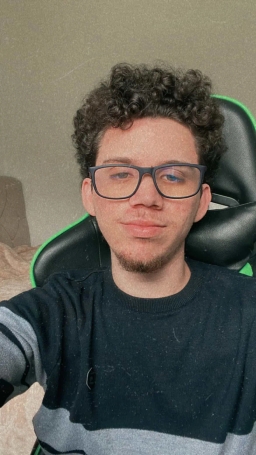 Cristian Fonseca, with glasses, smiling and curly hair.